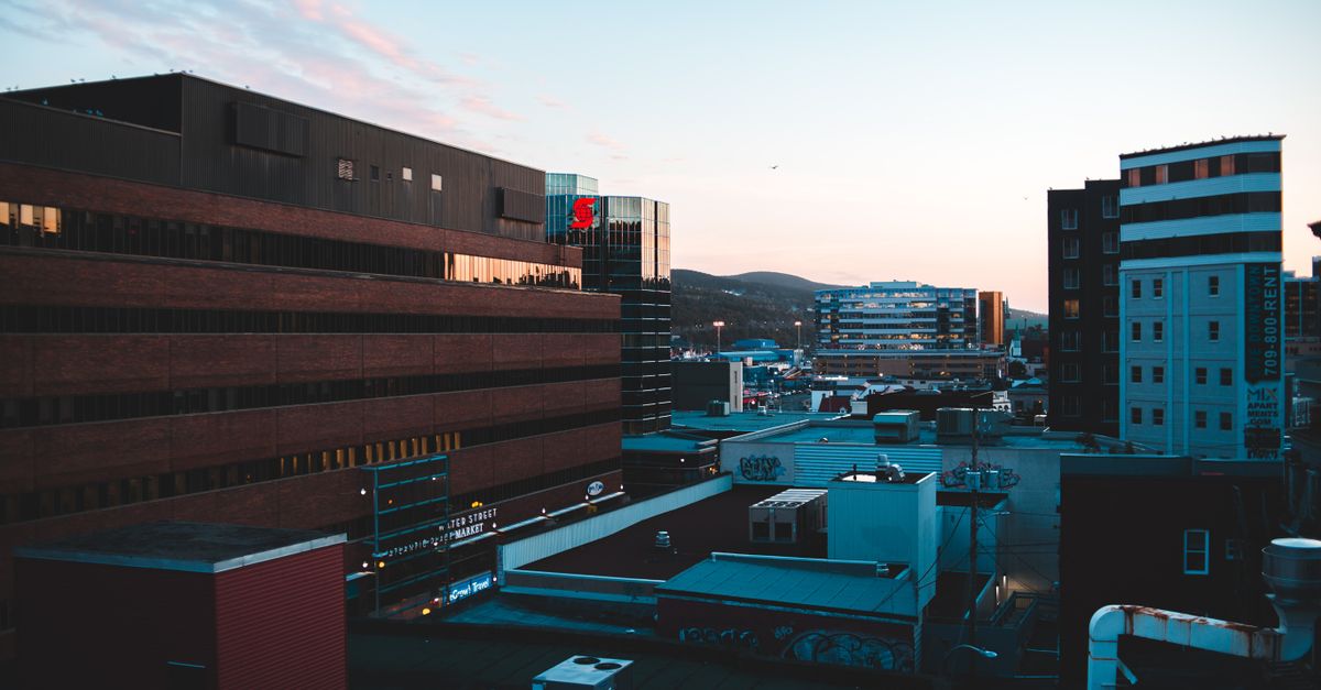 Captivating twilight view of urban buildings under a blue sky, reflecting the modern cityscape.