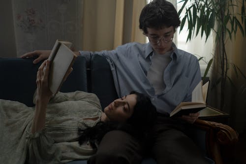 Couple on Sofa Reading Books