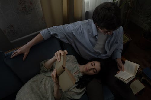 High Angle Shot of Couple Reading Books Together