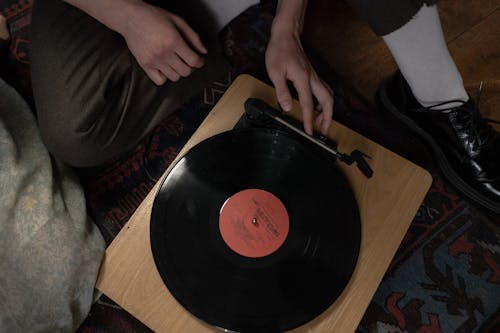 Person holding a Wooden Phonograph Player 