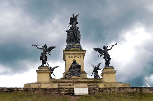 Statues Under a Cloudy Sky