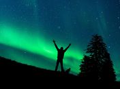 Silhouette of Man Standing on Rock Under Starry Night