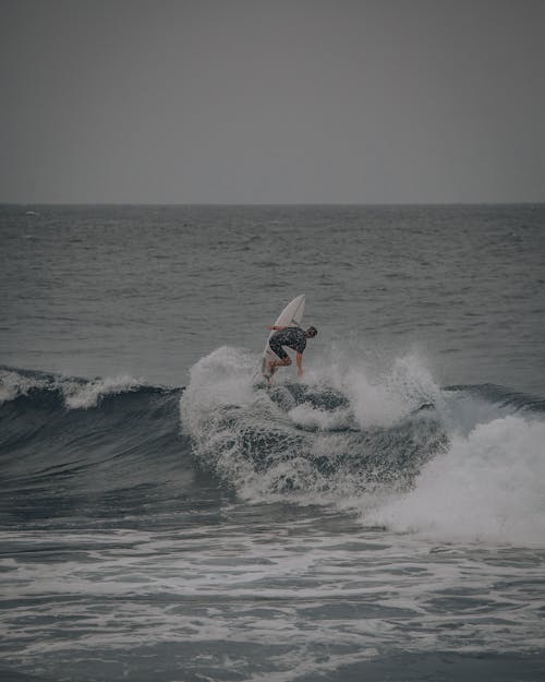 Person Surfing on Sea Waves