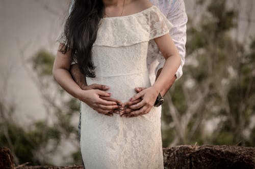 Free Pregnant Woman in White Floral Dress Stock Photo