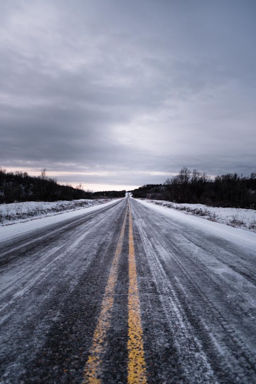 Free Yellow Markings on Snow Covered Road Stock Photo