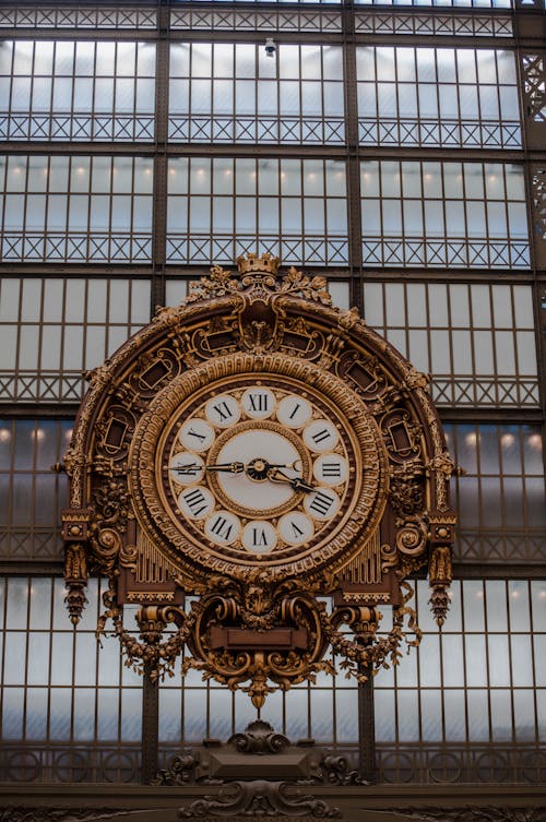 Free Round Golden Clock on Glass Panels Stock Photo
