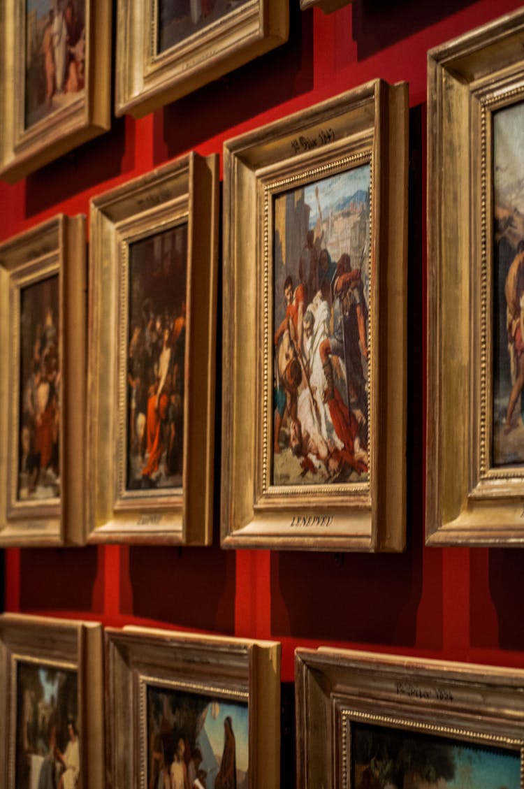 Gold Framed Paintings On A Red Wall