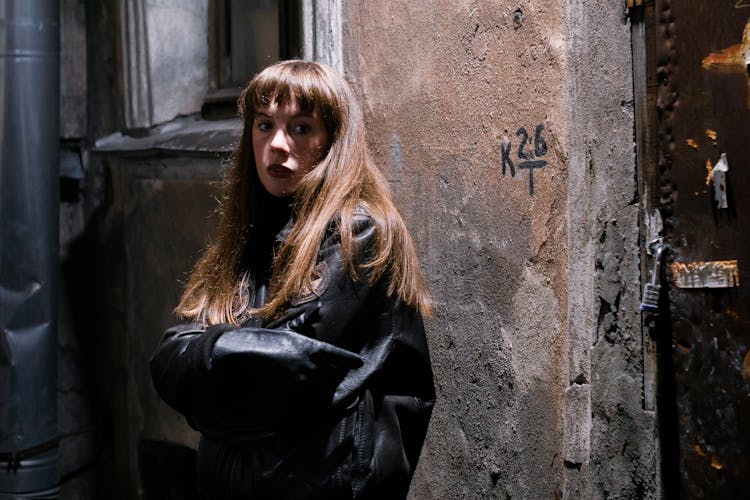 Cool Teen In Leather Jacket Near Old Cement Building