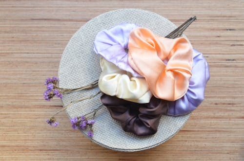 Assorted hair ties with flower sprigs on round shaped box
