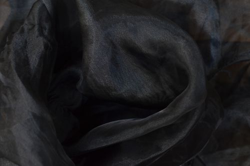 Free Overhead view of textured backdrop of crumpled black fabric with thin texture and wavy surface Stock Photo