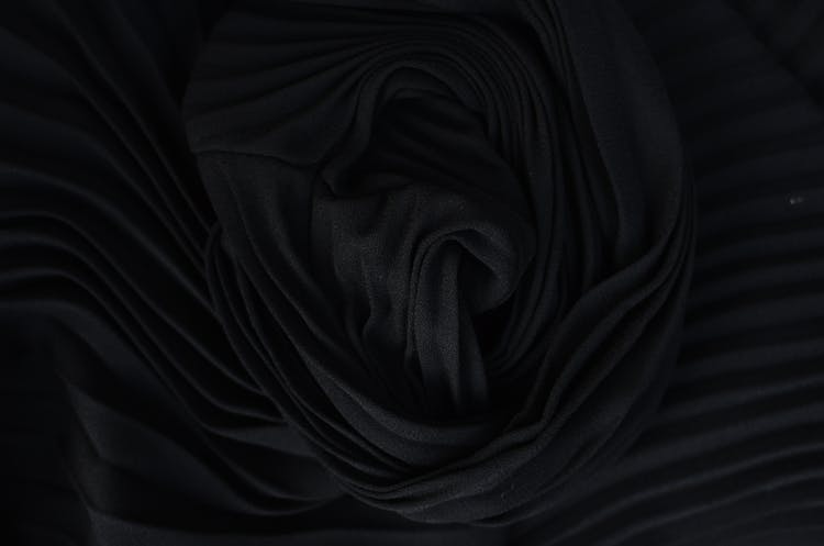 Textured Backdrop Of Soft Crumpled Textile In Darkness