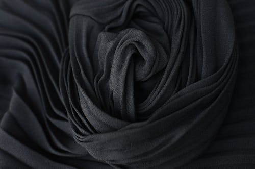 Top view abstract textured background of dark gray pleated textile placed on table