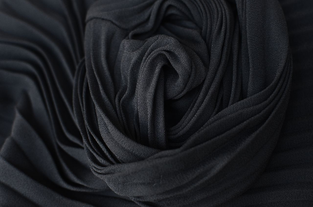 top view abstract textured background of dark gray pleated textile pla