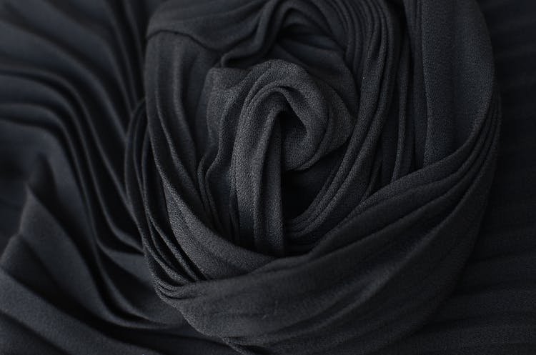 Black Pleated Fabric Placed On Table