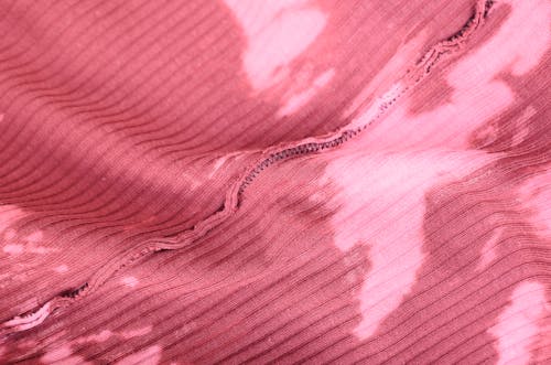 Free Top view abstract background of pink knitted textile with inside seam and stains Stock Photo