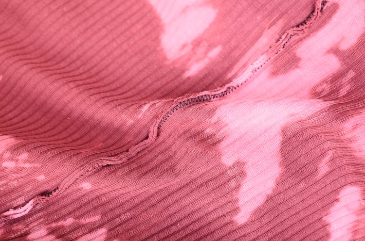 Pink Knitted Fabric With Inside Seam And Stains