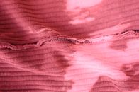 Top view pink knitted fabric with stains and inside seam placed on table