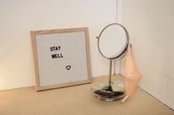Reusable face mask hanging on table mirror