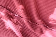 Top view abstract background of pink knitted textile with stains placed on table inside out