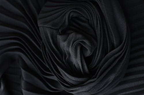 Free Black pleated fabric placed on table Stock Photo