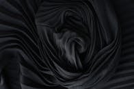 Black pleated fabric placed on table