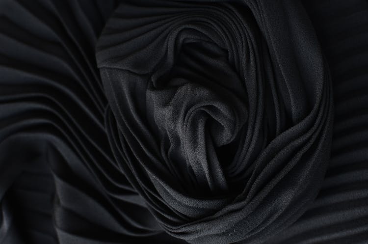 Black Pleated Fabric Placed On Table