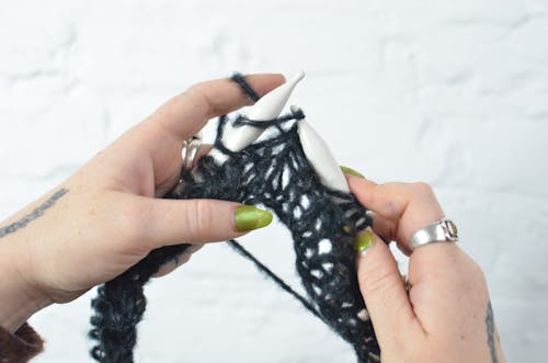 Woman knitting with needles in hand