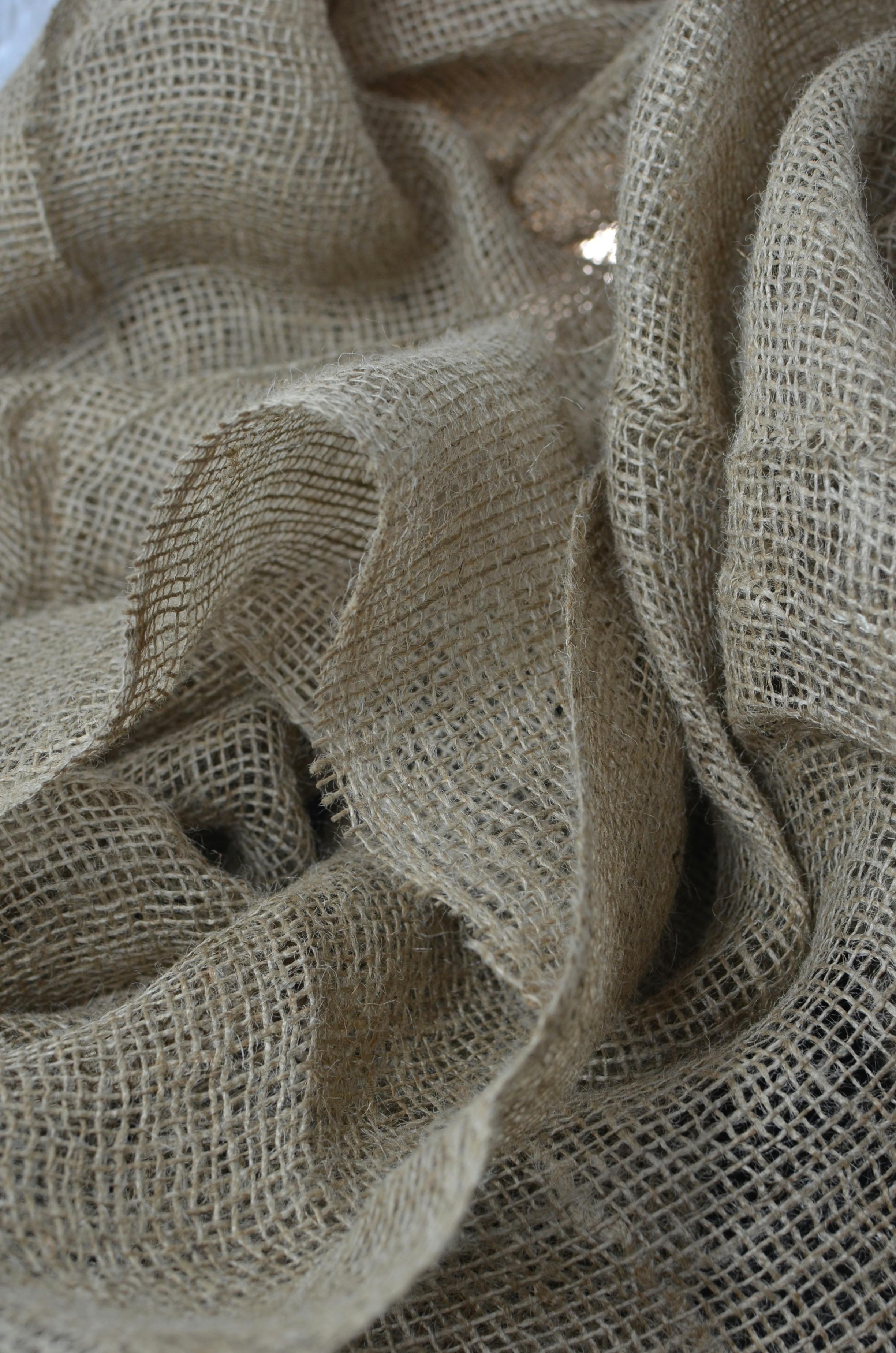 textured backdrop of organic burlap with tiny holes