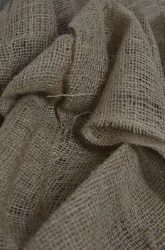 Close-up shot of coarse burlap fabric showcasing natural texture and pattern.