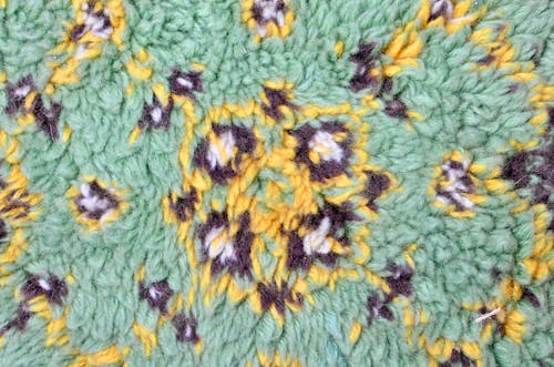 Top view of textured backdrop representing soft rug with bright symmetrical decor in daylight