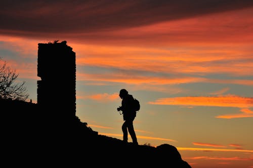 Free Man Standing on a Rock Formation Stock Photo