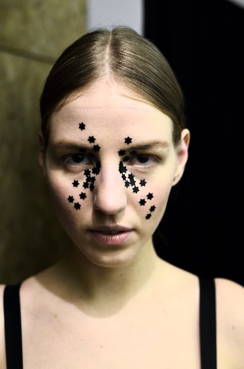 Young woman with decorative stars on face