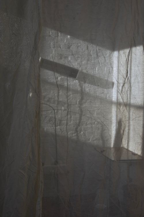 Free View from cloth hanging in room with table and lamp hanging on brick white wall Stock Photo