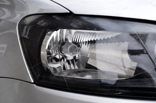 Shiny headlight of modern metallic car
