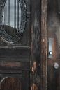 Shabby aged wooden doors with scratches at entrance of damaged worn out house