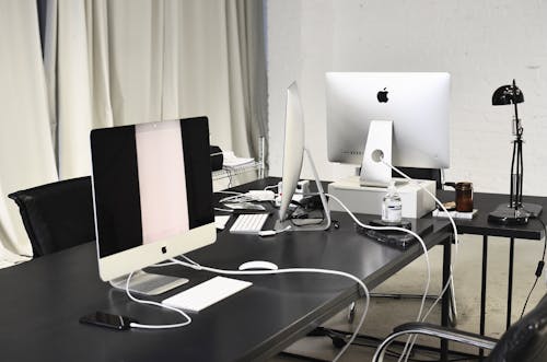 Interior of business workplace with various modern gadgets placed on table in office