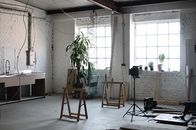 Interior of loft with brick wall with wires hanging on ceiling and tools for renovation  works