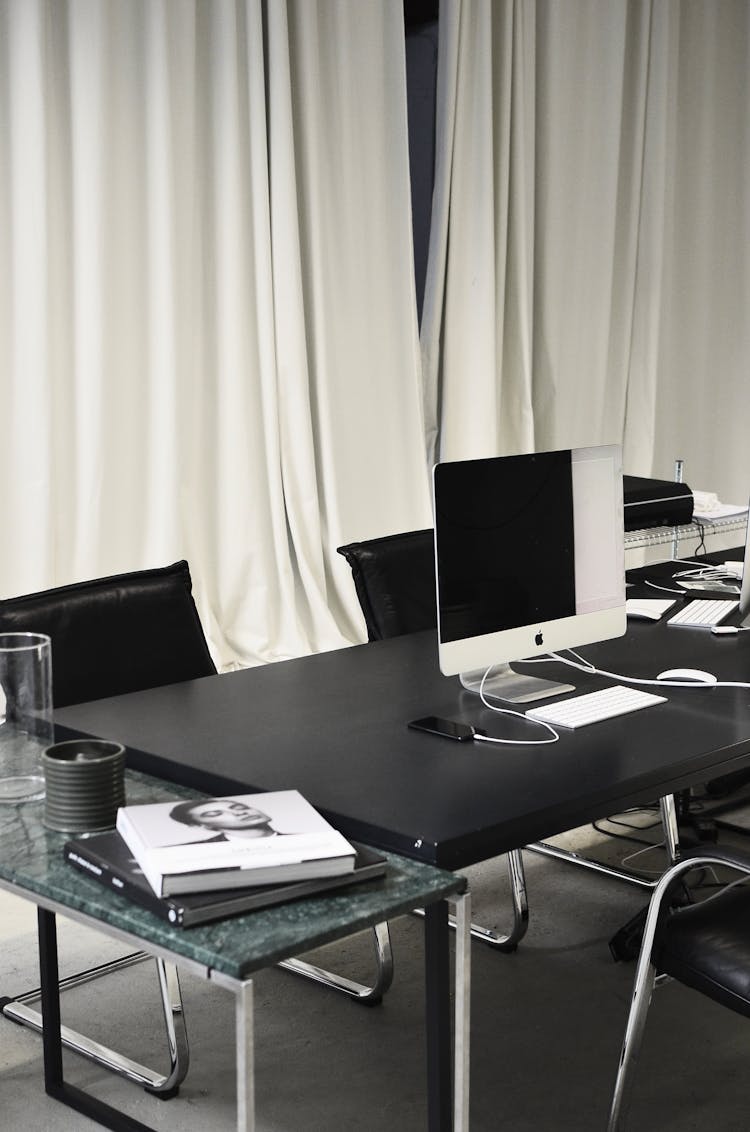 Modern Convenient Computer Placed On Table In Office With Curtains