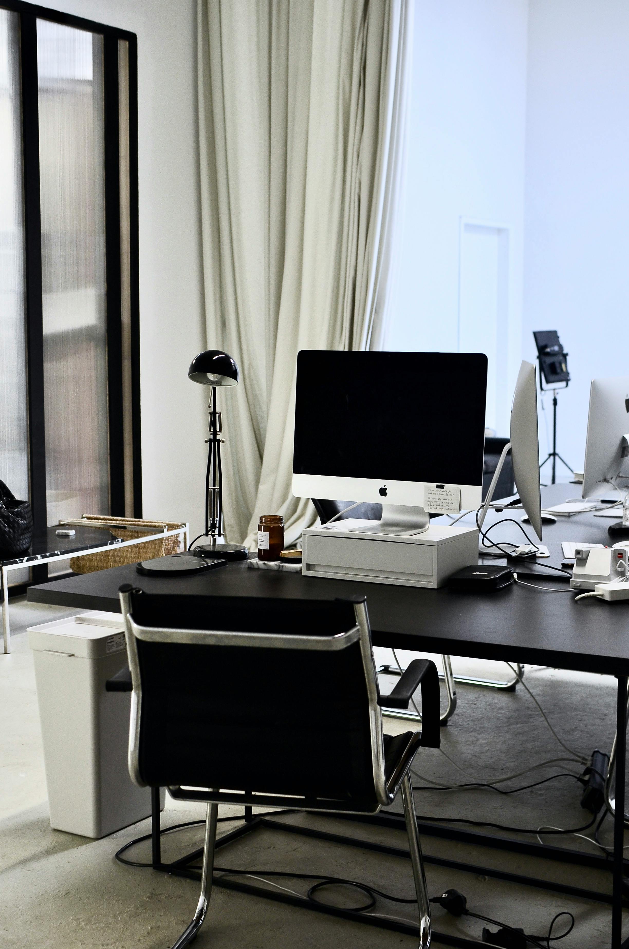 contemporary workspace with computer on table and chair in office