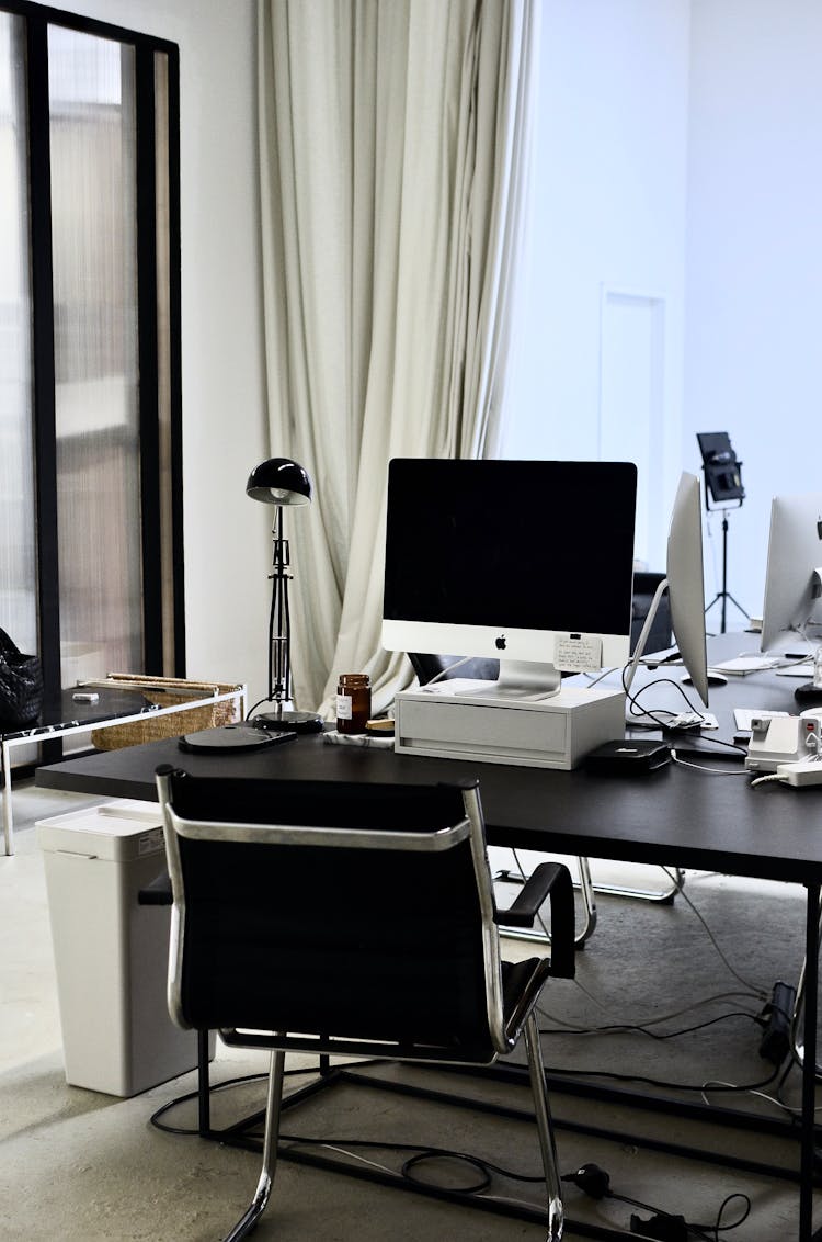 Contemporary Workspace With Computer On Table And Chair In Office