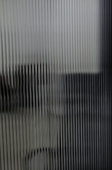 Blurred vertical lines create an abstract texture in a modern office environment, perfect for backgrounds.