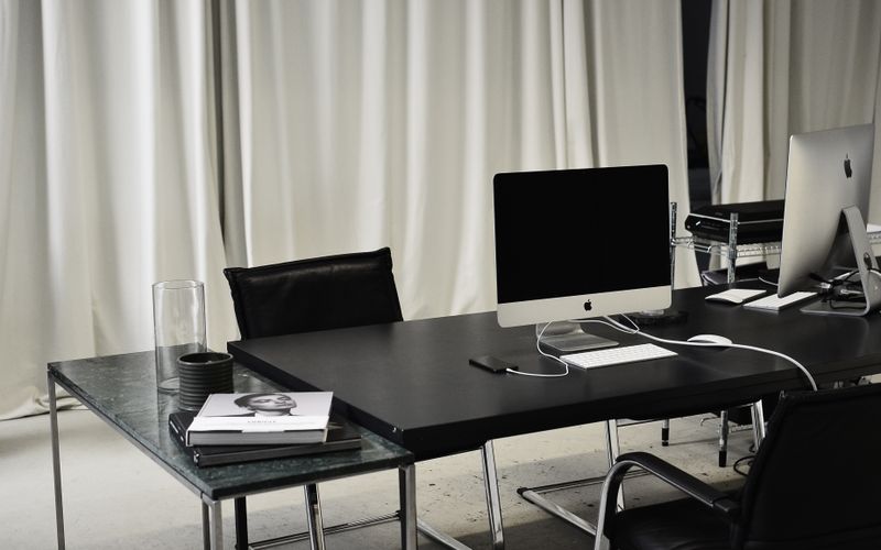 Minimal black and white workspace with a computer