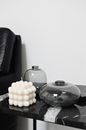 Black and white of decorative wax candle with glass vases reflecting room in house