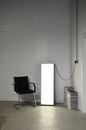 Shiny lamp near armchair in empty room