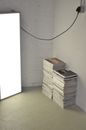 Stacked magazines on floor near photo studio lamp