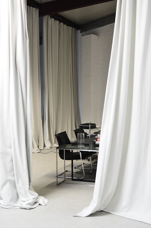 Conference room with meeting table surrounded by curtains