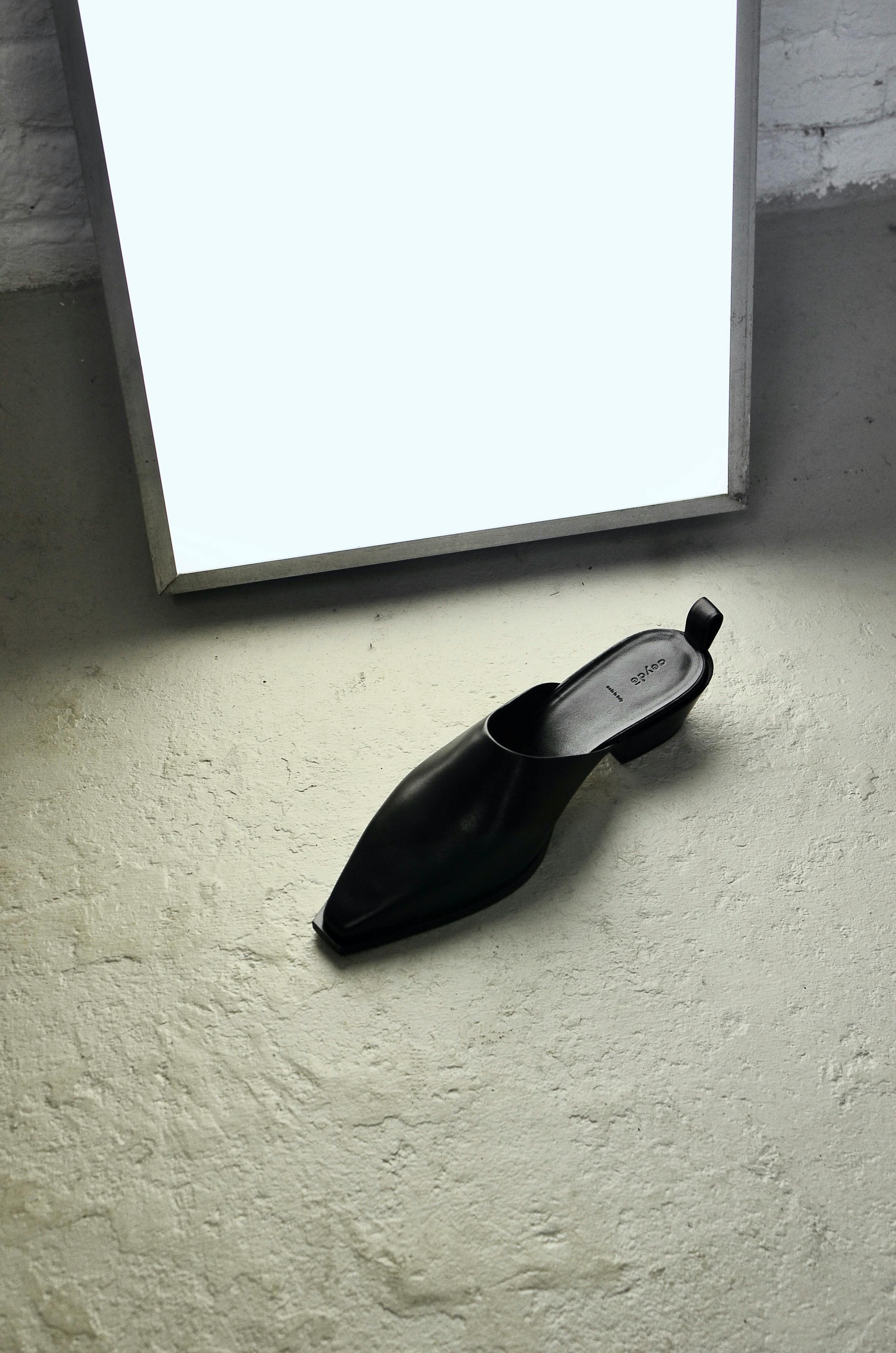 stylish shoe on floor near soft light lamp