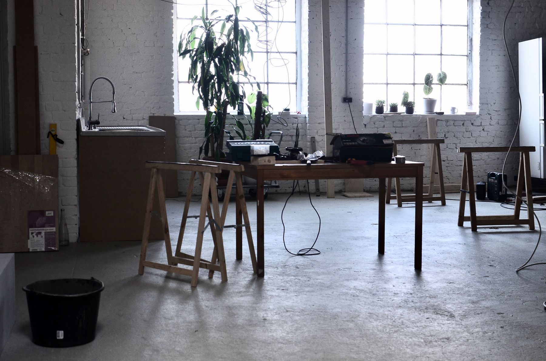 Apartment workspace with desk, shelving, task light and surrounding living architecture