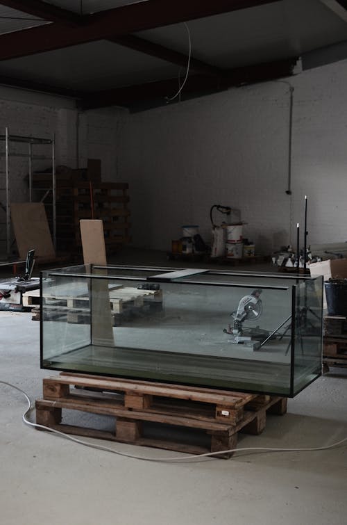 Spacious workshop with empty glass aquarium on wooden stand