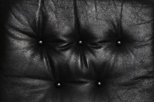 Free Cushion of black leather weathered sofa Stock Photo